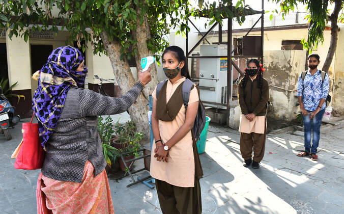India: Schools reopened after 10 months in Rajasthan Students undergo thermal screening as they arrive to attend classes at a government school that was reopened after remaining closed for 309 days due to COVID-19 pandemic in Beawar. Beawar Rajasthan India Copyright: SumitxSaraswat