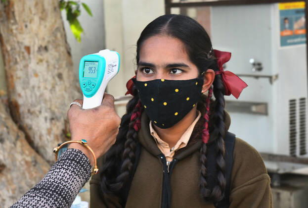 India: Schools reopened after 10 months in Rajasthan Student undergo thermal screening as she arrive to attend class at a government school that was reopened after remaining closed for 309 days due to COVID-19 pandemic in Beawar. Beawar Rajasthan India Copyright: SumitxSaraswat