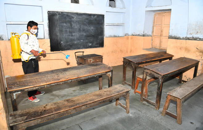 India: Schools reopened after 10 months in Rajasthan Worker sanitise a classroom at a school that was reopened after remaining closed for 309 days due to COVID-19 pandemic in Beawar. Beawar Rajasthan India Copyright: SumitxSaraswat