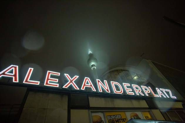 TV Tower enclosed by fog and rain, persistent rain and temperatures around the freezing point provide sleet and low clouds The clouds and sleet enclose the TV Tower, for the next days warmer temperatures are expected In the foreground you can see the illuminated lettering Alexanderplatz at Alexanderplatz station Berlin Mitte Berlin Germa