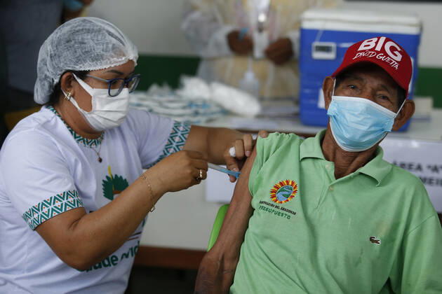 (210120) -- AMAZONAS, Jan. 20, 2021 -- A man receives a dose of China s COVID-19 vaccine in the city of Tabatinga in the state of Amazonas, Brazil, Jan. 19, 2021. Brazil launched a mass immunization campaign against the COVID-19 pandemic in every state starting at 5:00 p.m. Monday local time (2000 GMT). As of Monday afternoon, all states were expected to have received their doses of the CoronaVac vaccine developed by Chinese laboratory Sinovac in collaboration with the Butantan Institute of Sao Paulo, one of the world s leading scientific research centers. (Photo by Xinhua) BRAZIL-AMAZONAS-COVID-19-VACCINE-MASS INOCULATION LucioxTavora 