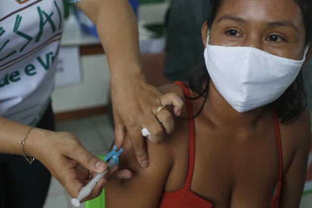 (210120) -- AMAZONAS, Jan. 20, 2021 -- A woman receives a dose of China s COVID-19 vaccine in the city of Tabatinga in the state of Amazonas, Brazil, Jan. 19, 2021. Brazil launched a mass immunization campaign against the COVID-19 pandemic in every state starting at 5:00 p.m. Monday local time (2000 GMT). As of Monday afternoon, all states were expected to have received their doses of the CoronaVac vaccine developed by Chinese laboratory Sinovac in collaboration with the Butantan Institute of Sao Paulo, one of the world s leading scientific research centers. (Photo by Xinhua) BRAZIL-AMAZONAS-COVID-19-VACCINE-MASS INOCULATION LucioxTavora 