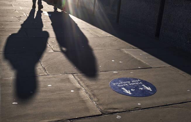 January 22, 2021, London, United Kingdom: A silhouette cast next to the floor sticker saying Please keep your distance in the city of London. London United Kingdom - ZUMAs197 20210122_zab_s197_031 Copyright: xMayxJamesx