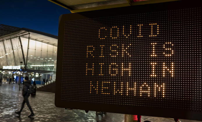 January 23, 2021, London, United Kingdom: A person passing the COVID sign read Ã¢â‚¬oeCovid risk is high in NewhamÃ¢â‚¬Â in Stratford, the London Borough of Newham, England, UK on January 23, 2021. Some of England s Covid hotspots are still in London Hounslow, Ealing, Brent, Barking and Dagenham and Newham are the boroughs which fall in the country s top 10 for worst case rates. London United Kingdom - ZUMAj323 20210123_zip_j323_015 Copyright: xMayxJamesx