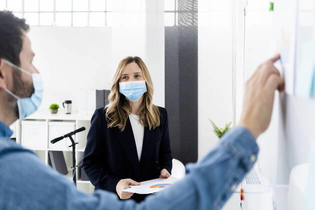 IMAGO Creative: 2022 Aussichten Business people wearing protective masks working in office model released Symbolfoto property released GIOF10443