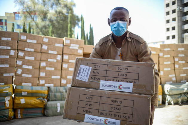 (210127) -- ADDIS ABABA, Jan. 27, 2021 -- A staff member carries medical supplies donated by the China Chamber of Commerce in Addis Ababa, Ethiopia on Jan. 26, 2021. The China Chamber of Commerce in Ethiopia (CCCE) on Tuesday donated 500,000 washable masks and 10,000 thermometers to the Ethiopia Ministry of Education (MoE). ) ETHIOPIA-CHINA-DONATION CEREMONY-MEDICAL SUPPLIES MichaelxTewelde 