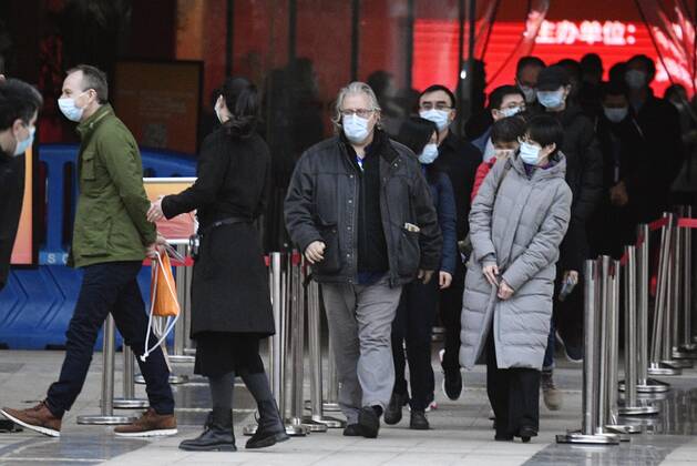 WHO probe into coronavirus origins in Wuhan Members of the World Health Organization s team investigating the origins of the coronavirus pandemic are pictured after visiting an exhibition about China s fight against the virus on Jan. 30, 2021, in Wuhan. 