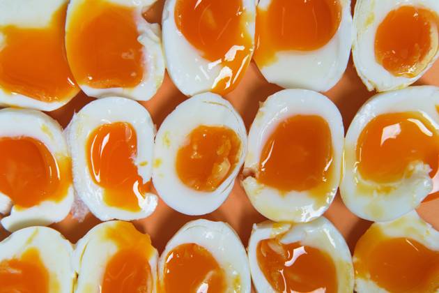Top view of full frame background of fresh soft boiled eggs arranged in rows on table Copyright: xFatimaxGuisadox Model Released