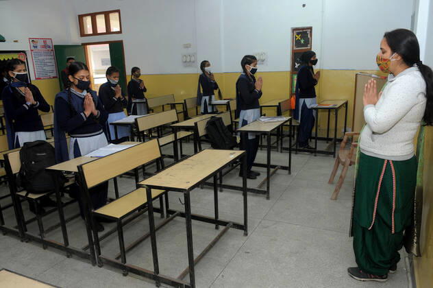 CHANDIGARH, INDIA - FEBRUARY 1: Students attending morning prayers in their classroom after classes resumed for grades 6 to 8 for the first time since the lockdown, at a government school in Sector 50, on February 1, 2021 in Chandigarh, India. (Photo by Ravi Kumar Hindustan Times) Daily Life Amid Covid-19 Pandemic In India