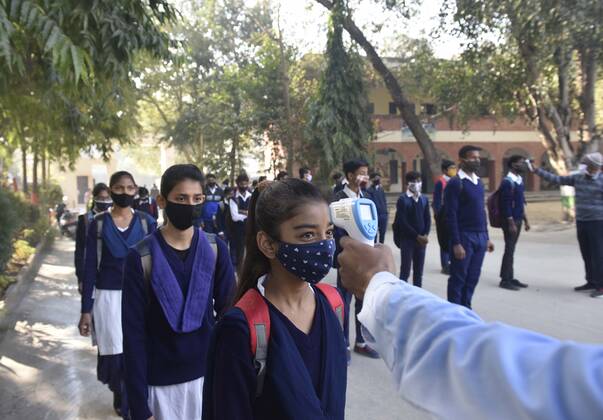 GURUGRAM, INDIA - FEBRUARY 1: A student undergoes thermal screening before entering Model Senior Secondary School Urban Estate at Sector 4, on February 1, 2021 in Gurugram, India. Schools in Gurugram reopened for 6th to 8th standard today. (Photo by Vipin Kumar Hindustan Times) Daily Life Amid Covid-19 Pandemic In India