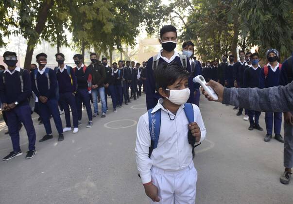 GURUGRAM, INDIA - FEBRUARY 1: A student undergoes thermal screening before entering Model Senior Secondary School Urban Estate at Sector 4, on February 1, 2021 in Gurugram, India. Schools in Gurugram reopened for 6th to 8th standard today. (Photo by Vipin Kumar Hindustan Times) Daily Life Amid Covid-19 Pandemic In India