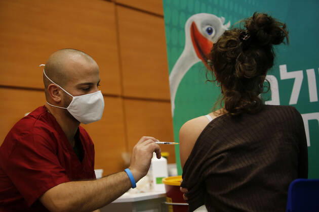 (210201) -- TEL AVIV, Feb. 1, 2021 -- A woman receives the COVID-19 vaccine at a health service center in Tel Aviv, Israel, on Feb. 1, 2021. Israel s Ministry of Health reported 8,399 new COVID-19 cases on Monday, bringing the tally in the country to 651,405. The number of people vaccinated against the COVID-19 in Israel has surpassed 3.14 million, or 33.8 percent of its total population, since the vaccination campaign began on Dec. 20, 2020. (Photo by Xinhua) ISRAEL-TEL AVIV-COVID-19-VACCINATION GilxCohenxMagen