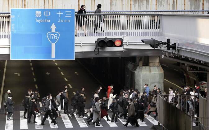 Japan to extend virus emergency to March 7 as hospitals strained People wearing face masks walk in front of JR Osaka Station on Feb. 2, 2021. The Japanese government is set to extend a coronavirus state of emergency for Tokyo, Osaka and other regions by one month to March 7 in view of manpower-strapped hospitals amid a surge in serious patients. 