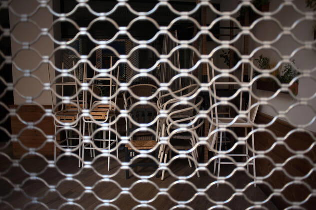 February 2, 2021, Malaga, Spain: Chairs stacked inside Volapie closed bar during the closure of the hospitality sector and non-essential activities as part of a partial lockdown..For two weeks, besides the limit on mobility between cities, many municipalities and Costa del Sol districts (including the Malaga capital) will have to close bars, restaurants and stores as measures to curb the spread of the coronavirus pandemic. In the lead of Andalusia, Malaga is the city with more daily coronavirus infections and a high rate of hospitalizations. Malaga Spain - ZUMAs197 20210202_zab_s197_013 Copyright: xJesusxMeridax