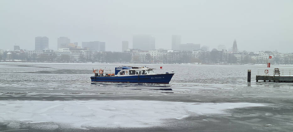 Hamburg in Corona Lockdown scenes in February 2021 around the Hamburg Außenalster scenes from the lockdown at the Alster in Hamburg police boat WS police 19 on the Alster with ice police boat ship Hamburg in Corona Lockdown scenes in February 2021 around the Hamburg Außenalster , Hamburg Hamburg Germany downtown around the Alster