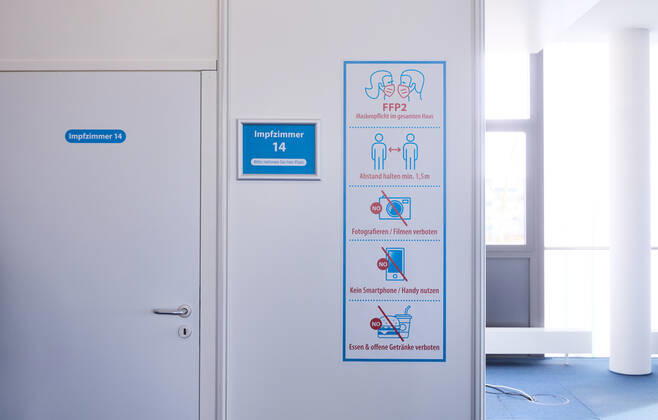 Signs in front of a vaccination room in the Bavarian Vaccination Center Augsburg, press tour Bavarian Vaccination Center Augsburg, press tour