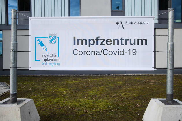 Guilt, banner in front of the vaccination centre Bavarian Vaccination Centre Augsburg, press tour Bavarian Vaccination Centre Augsburg, press tour