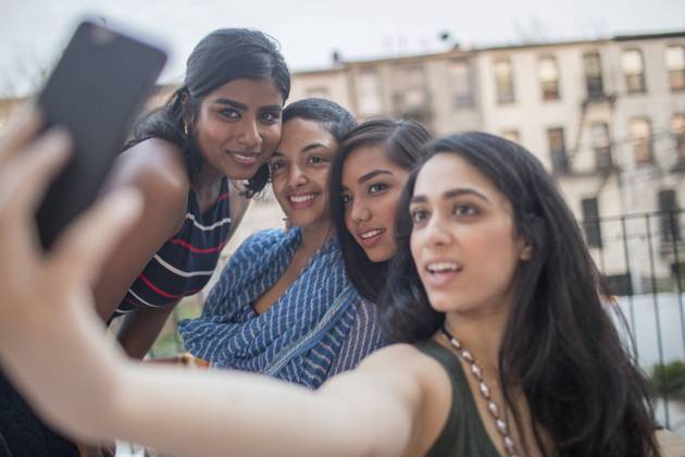 Young women taking a selfie at a party together model release HEX17012_TP_-9542 Copyright: xTOBIASxPRASSEx