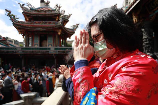 February 12, 2021, Taipei, Taipei, Taiwan: A Taiwanese wearing a mask pays worships at Lungshan Temple that was build during the World War II, as the Year of the Ox has come alongside the Lunar New Year Festival, amidst the Covid-19 pandemic. The islandÃ¢â‚¬â ¢s authority has put large gatherings, activities for festival celebration in cancellation or suspension due to a domestic outbreak. Taipei Taiwan - ZUMAs313 20210212_zip_s313_003 Copyright: xDanielxCengxShou-Yix