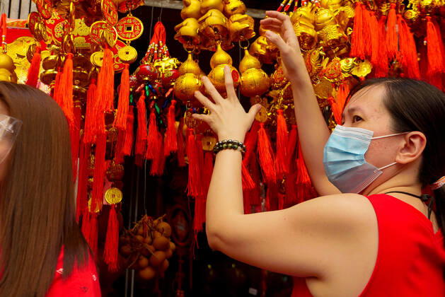 February 12, 2021, Manila, National Capital Region, Philippines: A passerby ignores the vendor selling lucky Chinese lanterns...Manila cancels the dragon dance and lion dance this Chinese New Year due to the pandemic. Manila Philippines - ZUMAb178 20210212_zap_b178_004 Copyright: xGeorgexBuidx