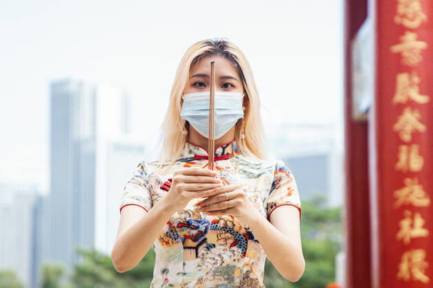 February 12, 2021, Kuala Lumpur, Malaysia: A woman offers prayers while holding a joss stick at the Thean Hou Temple during the Lunar New Year. Kuala Lumpur Malaysia - ZUMAs197 20210212_zaa_s197_101 Copyright: xAnnicexLynx