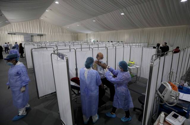 (210214) -- BEIRUT, Feb. 14, 2021 -- An elderly staff member of the Saint George Hospital receives a dose of vaccine against COVID-19 in Beirut, Lebanon, on Feb. 14, 2021. Lebanon launched on Sunday its vaccination campaign by starting with employees in the health sector after receiving, a day earlier, 28,500 vaccines from Pfizer-BioNTech, LBCI local TV channel reported. ) LEBANON-BEIRUT-COVID-19-VACCINATION BilalxJawich 