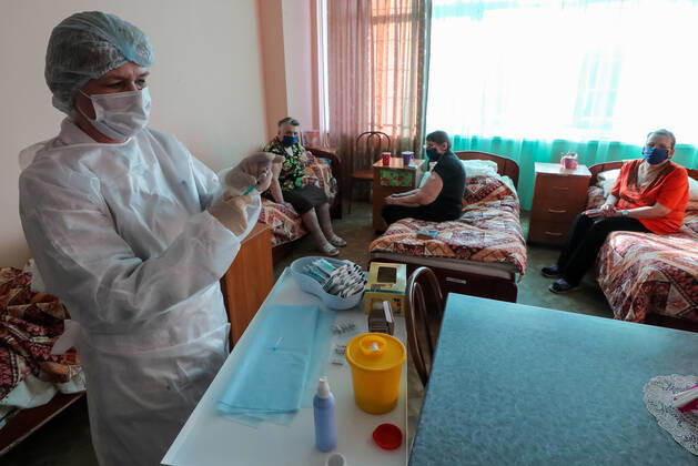 ST PETERSBURG, RUSSIA â€” FEBRUARY 15, 2021: A medical worker fills a syringe with the Gam-COVID-Vac vaccine (under the brand name of Sputnik V) while vaccinating people against COVID-19 at No 7 Neuropsychiatric Care Home. Alexander Demianchuk TASS  TS0F6D0C