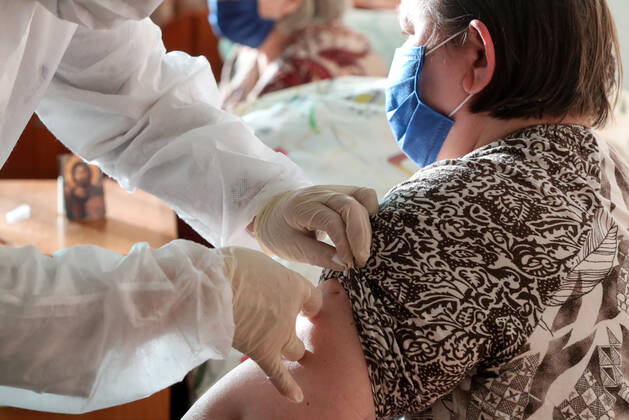 ST PETERSBURG, RUSSIA â€” FEBRUARY 15, 2021: A medical worker injects a patient with the Gam-COVID-Vac vaccine (under the brand name of Sputnik V) at No 7 Neuropsychiatric Care Home. Alexander Demianchuk TASS  TS0F6D19