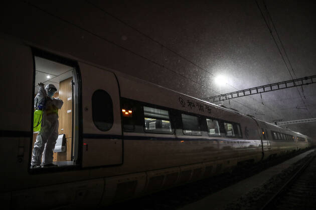 (210216) -- SHENYANG, Feb. 16, 2021 -- Wang Tong, a mechanic of China Railway Shenyang Bureau, puts on protective gears on a train in Shenyang, capital of northeast China s Liaoning Province, Feb. 14, 2021. Since December last year, some areas in China s northeastern Heilongjiang, Jilin, and Liaoning Provinces reported newly confirmed COVID-19 cases. Related areas responded immediately according to epidemic prevention requirements. Mass nucleic acid testing were conducted in key areas in an effort to stem the spread of the coronavirus. Recently, no new confirmed COVID-19 cases have been reported here for several days. During the Spring Festival vacation, many workers stick to their posts to make sure people can celebrate the festival safel