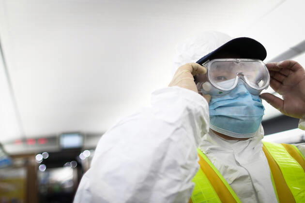 (210216) -- SHENYANG, Feb. 16, 2021 -- Wang Tong, a mechanic of China Railway Shenyang Bureau, adjusts his goggle on a train in Shenyang, capital of northeast China s Liaoning Province, Feb. 14, 2021. Since December last year, some areas in China s northeastern Heilongjiang, Jilin, and Liaoning Provinces reported newly confirmed COVID-19 cases. Related areas responded immediately according to epidemic prevention requirements. Mass nucleic acid testing were conducted in key areas in an effort to stem the spread of the coronavirus. Recently, no new confirmed COVID-19 cases have been reported here for several days. During the Spring Festival vacation, many workers stick to their posts to make sure people can celebrate the festival safely. ) C