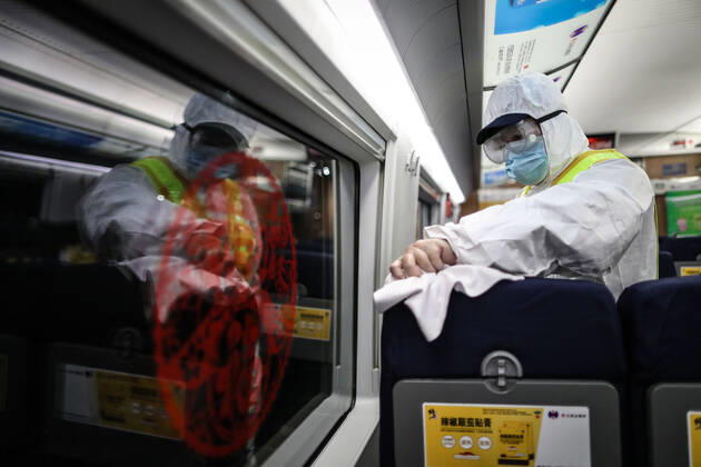 (210216) -- SHENYANG, Feb. 16, 2021 -- Wang Tong, a mechanic of China Railway Shenyang Bureau, disinfects a train in Shenyang, capital of northeast China s Liaoning Province, Feb. 14, 2021. Since December last year, some areas in China s northeastern Heilongjiang, Jilin, and Liaoning Provinces reported newly confirmed COVID-19 cases. Related areas responded immediately according to epidemic prevention requirements. Mass nucleic acid testing were conducted in key areas in an effort to stem the spread of the coronavirus. Recently, no new confirmed COVID-19 cases have been reported here for several days. During the Spring Festival vacation, many workers stick to their posts to make sure people can celebrate the festival safely. ) CHINA-SPRING
