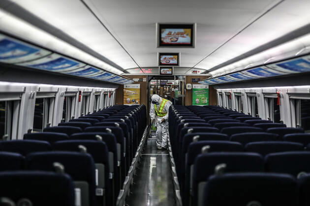 (210216) -- SHENYANG, Feb. 16, 2021 -- Wang Tong, a mechanic of China Railway Shenyang Bureau, disinfects a train in Shenyang, capital of northeast China s Liaoning Province, Feb. 14, 2021. Since December last year, some areas in China s northeastern Heilongjiang, Jilin, and Liaoning Provinces reported newly confirmed COVID-19 cases. Related areas responded immediately according to epidemic prevention requirements. Mass nucleic acid testing were conducted in key areas in an effort to stem the spread of the coronavirus. Recently, no new confirmed COVID-19 cases have been reported here for several days. During the Spring Festival vacation, many workers stick to their posts to make sure people can celebrate the festival safely. ) CHINA-SPRING
