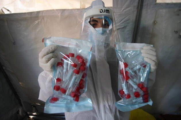 A Palestinian paramedic wearing a full protective suit, organizes COVID-19 tests on Tuesday, in Khan Yunis, southern of Gaza, February 16, 2021. The Palestinian Authority claims that Israel is stopping delivery of COVID-19 vaccines into Gaza, from the West Bank.  GAZ2021021618 IsmaelxMohamad