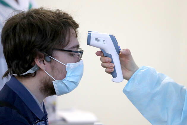 YEKATERINBURG, RUSSIA - FEBRUARY 17, 2021: A woman has her temperature measured in a mobile COVID-19 vaccination unit set up at the Dirizhabl Airship shopping centre, injections of the Gam-COVID-Vac (Sputnik-V) free of charge, no prior appointment required. Donat Sorokin TASS  TS0F701C