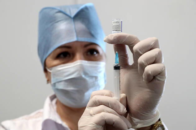 MOSCOW, RUSSIA â€“ FEBRUARY 17, 2021: A nurse fills a syringe with the Gam-COVID-Vac vaccine (under the brand name of Sputnik V) at a new temporary COVID-19 vaccination site in the VDNKh Exhibition Centre. A mobile vaccination team is providing vaccines free of charge and without prior sign-up. Since the start of the pandemic, Moscow has confirmed more than 960,600 cases of COVID-19. Since late January, the number of new confirmed cases has been increasing in the Russian capital by more than 1,200 daily. Sergei Savostyanov TASS  TS0F7011