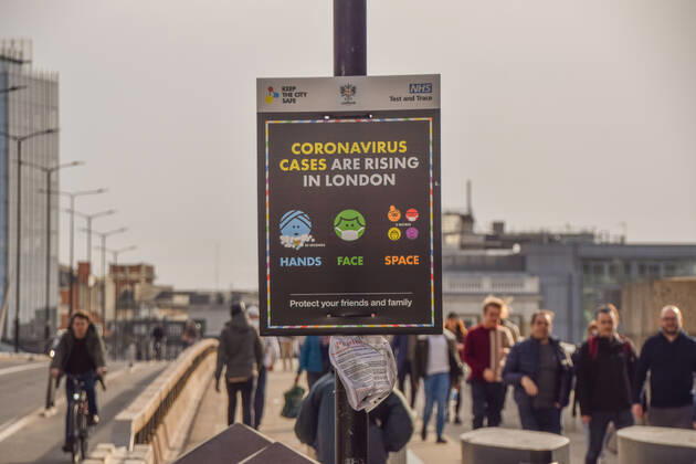 February 20, 2021, London, United Kingdom: People walk past the Coronavirus Cases Are Rising In London sign on London Bridge..Most businesses remain closed in the capital, as the government plans to ease the lockdown restrictions in the coming weeks. London United Kingdom - ZUMAs197 20210220_zab_s197_004 Copyright: xVukxValcicx