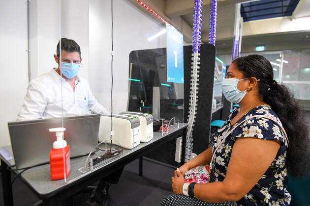 NSW COVID19 VACCINE ROLLOUT, Gayathry Vellangalloor Srinivasan, the first person in NSW to received the Pfizer coronavirus vaccine, registers with medial workers at the Royal Prince Alfred Hospital Vaccination Hub in Sydney, Monday, February 22, 2021. Australia will begin its roll out of the Pfizer coronavirus vaccine on Monday, the country s most complicated logistical exercise to date. ( NO ARCHIVING, EDITORIAL USE ONLY, NO USE IN BOOKS WITHOUT CONSENT SYDNEY NSW AUSTRALIA  Copyright: xPETERxRAEx 20210222001522241395