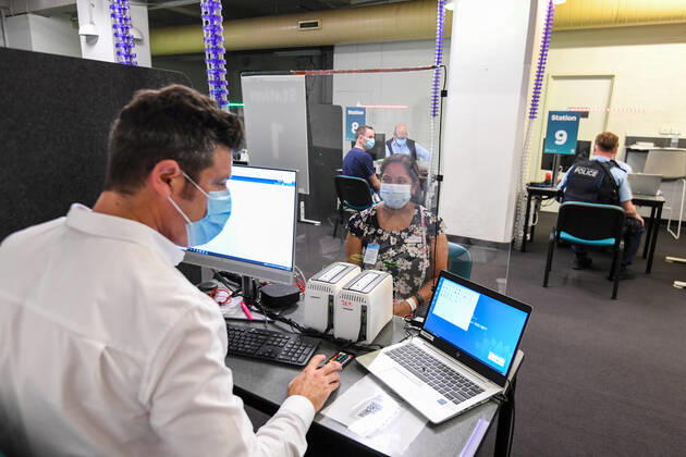 NSW COVID19 VACCINE ROLLOUT, Gayathry Vellangalloor Srinivasan, the first person in NSW to received the Pfizer coronavirus vaccine, registers with medial workers at the Royal Prince Alfred Hospital Vaccination Hub in Sydney, Monday, February 22, 2021. Australia will begin its roll out of the Pfizer coronavirus vaccine on Monday, the country s most complicated logistical exercise to date. ( NO ARCHIVING, EDITORIAL USE ONLY, NO USE IN BOOKS WITHOUT CONSENT SYDNEY NSW AUSTRALIA Copyright: xPETERxRAEx 20210222001522244642