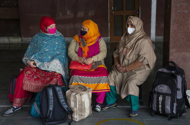 (210223) -- SRINAGAR, Feb. 23, 2021 -- Passengers wearing face masks wait for a train at a train station in Srinagar city, the summer capital of Indian-controlled Kashmir, Feb. 23, 2021. Train service was resumed partially in Indian-controlled Kashmir after a gap of 11 months, officials said Tuesday. The service was suspended on March 19 last year owing to the outbreak of the COVID-19 pandemic. ) KASHMIR-TRAIN SERVICE-RESUMPTION JavedxDar 
