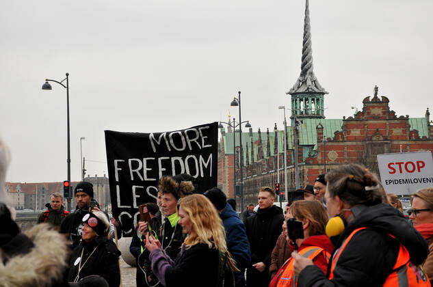 Copenhagen, Denmark. 23 February 2021, Danes proetesting againest coronavirus pandemic new debate in danish parliamenet about quick corona virus pandemic law in danish parliament with all political parties and stage anti pandemic law debates in front of danish parliament and danish police stand peaceful proteact danish parliament in front christiansborg danish parliament in Copenhagen. (Photo..Francis Dean Deanpictures)