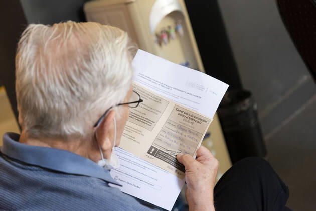 February 23, 2021, City of Buenos Aires, City of Buenos Aires, Argentina: INT. WorldNews. COVID-19. February 23, 2021. City of Buenos Aires, Argentina.- An old man reads his vaccine certificate for SARS CoV2 (COVID-19) on Feb 23, 2021, at a temporary Vaccination Center at Centro Cultural Recoleta, City of Buenos Aires, Argentina. Adults over 80 years old are being vaccinated for SARS CoV2 (COVID-19) since Feb 22, 2021 in City of Buenos Aires, Argentina. City of Buenos Aires Argentina - ZUMAf135 20210223_zap_f135_007 Copyright: xJulietaxFerrariox