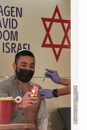 February 24, 2021, Jerusalem, Israel: The IDF Home Front Command in coordination with Magen David Adom, serving as the Israeli Red Cross organization and leading EMS, make COVID-19 vaccinating more accessible to those still in denial or refusal operating a mobile vaccination station out of a caravan at JerusalemÃ¢â‚¬â ¢s Shuk Mahane Yehuda Market. Jerusalem Israel - ZUMAa126 20210224_zap_a126_020 Copyright: xNirxAlonx