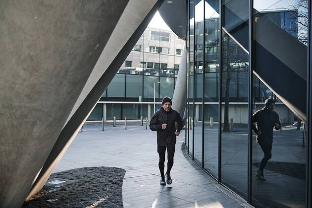 Mature runner running by glass wall building model released Symbolfoto ASGF00008