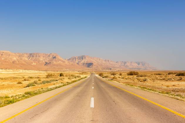 Dead Sea, Israel 23 February 2019 Endless road driving empty desert landscape lonely solitude infinite distance in Israel 1084204089