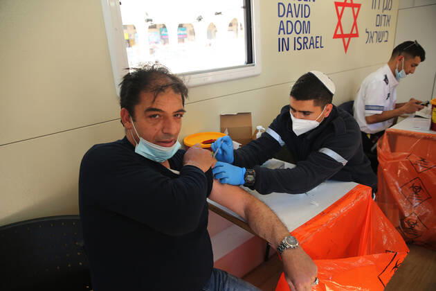 (210226) -- JERUSALEM, Feb. 26, 2021 -- A man receives the COVID-19 vaccine in a mobile clinic in Jerusalem, on Feb. 26, 2021. (Photo by Xinhua) MIDEAST-JERUSALEM-COVID-19-VACCINATION MuammarxAwad 