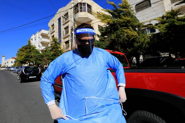 (210227) -- AMMAN, Feb. 27, 2021 -- A health worker prepares to collect samples for COVID-19 tests in Amman, Jordan, Feb. 26, 2021. Jordan on Wednesday decided to reinstate curfew on each Friday starting from Feb. 26 in addition to extending daily curfew by two hours as part of anti-pandemic measures as infections keep rising in the kingdom. During a press conference on Wednesday, Minister of State for Media Affairs Ali Al Ayed announced that businesses are allowed to operate until 9 p.m. local time while public movement will be permitted from 6 a.m. until 10 p.m. as of Thursday. (Photo by Xinhua) JORDAN-AMMAN-COVID-19-CURFEW MohammadxAbuxGhosh 