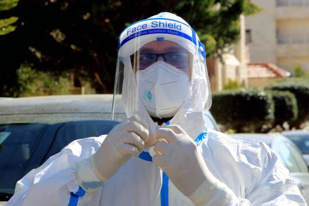 (210227) -- AMMAN, Feb. 27, 2021 -- A health worker prepares to collect samples for COVID-19 tests in Amman, Jordan, Feb. 26, 2021. Jordan on Wednesday decided to reinstate curfew on each Friday starting from Feb. 26 in addition to extending daily curfew by two hours as part of anti-pandemic measures as infections keep rising in the kingdom. During a press conference on Wednesday, Minister of State for Media Affairs Ali Al Ayed announced that businesses are allowed to operate until 9 p.m. local time while public movement will be permitted from 6 a.m. until 10 p.m. as of Thursday. (Photo by Xinhua) JORDAN-AMMAN-COVID-19-CURFEW MohammadxAbuxGhosh 