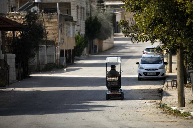 February 28, 2021, Jenin, West Bank, Palestinian Territory: A man walks on an empty street, amid the coronavirus lockdown in the town of Zababdeh, south of Jenin, in the West Bank on February 28, 2021. Prime Minister Mohammad Shtayyeh announced a new set of restrictions in response to a recent surge in coronavirus infections, including of British and South African mutants, in Palestine.A lockdown of all public and private schools for all classes, except for high school students for a period of 12 days, including kindergartens..A lockdown of all universities, educational and vocational institutes and shifting to distance e-learning programs. A maximum of 50 percent of administrative staff are allowed access to universities..Movement between - ZUMAap3_ 20210228_zaf_ap3_037 Copyright: xOdayxDaibesx