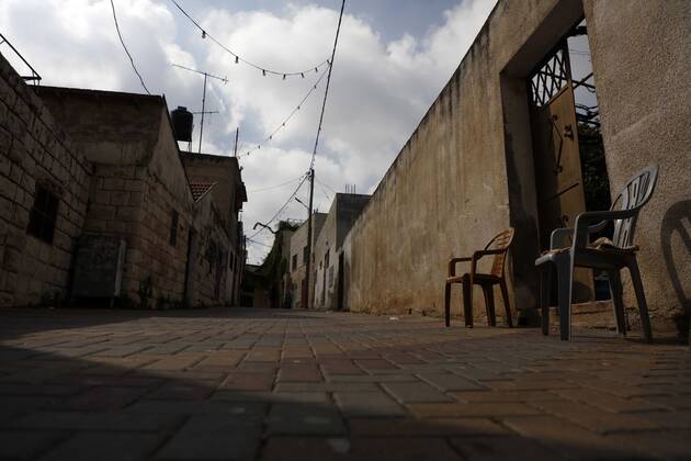 February 28, 2021, Jenin, West Bank, Palestinian Territory: A deserted street is pictured during a complete closure, amid the coronavirus lockdown in the town of Zababdeh, south of Jenin, in the West Bank on February 28, 2021. Prime Minister Mohammad Shtayyeh announced a new set of restrictions in response to a recent surge in coronavirus infections, including of British and South African mutants, in Palestine.A lockdown of all public and private schools for all classes, except for high school students for a period of 12 days, including kindergartens..A lockdown of all universities, educational and vocational institutes and shifting to distance e-learning programs. A maximum of 50 percent of administrative staff are allowed access to univer - ZUMAap3_ 20210228_zaf_ap3_050 Copyright: xOdayxDaibesx