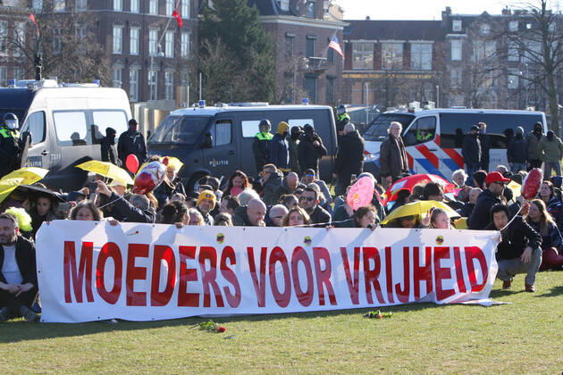 Anti-Lockdown supporters hold a banner Mother For Freedom during illegal demonstration against the coronavirus measures at the Museumplein on February 28, 2021 in Amsterdam,Netherlands. Amsterdam Mayor Femke Halsema classified the Museumplein as security risk area , giving police officers the right to check and search anybody in that area to prevent illegal demonstration and vandalism. Amsterdam Netherlands Copyright: xPauloxAmorimx amp20210228_004